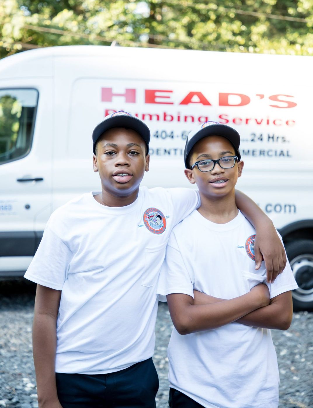 The next generation of the Head family in branded apparel beside a service van