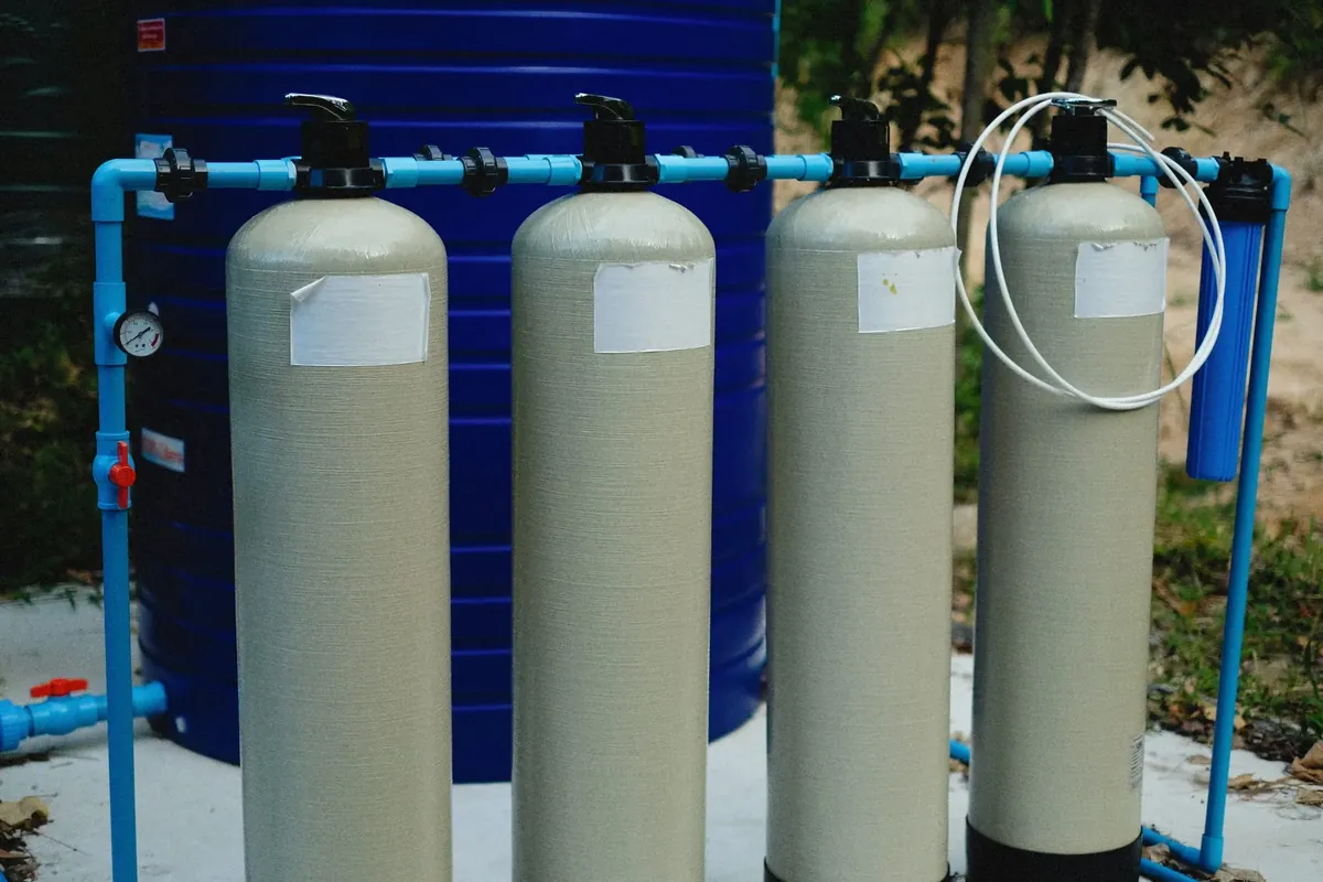 A whole-home water filtration system with multiple treatment tanks and supply piping